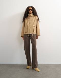 Model wearing Bubble hem trench in stone