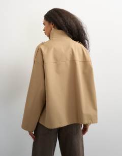 Model wearing Bubble hem trench in stone