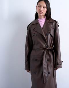 Model wearing Bubble PU faux leather trench coat in brown
