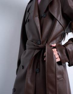 Model wearing Bubble PU faux leather trench coat in brown