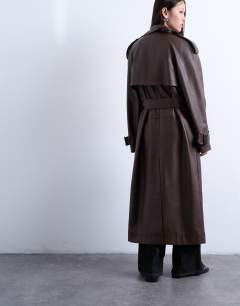 Model wearing Bubble PU faux leather trench coat in brown