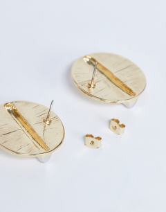 Model wearing Buffy statement stud earrings in gold