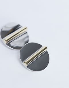 Model wearing Buffy statement stud earrings in silver