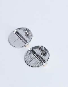 Model wearing Buffy statement stud earrings in silver