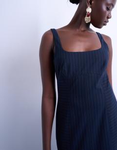 Model wearing Bust detail dropped hem midi dress in navy and red pinstripe