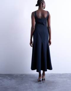 Model wearing Bust detail dropped hem midi dress in navy and red pinstripe