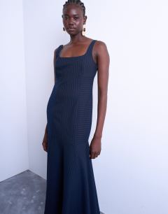 Model wearing Bust detail dropped hem midi dress in navy and red pinstripe