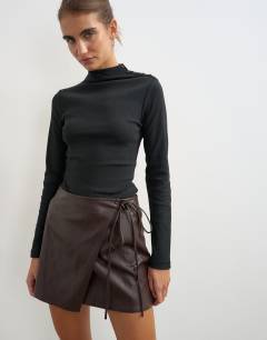 Model wearing Button detail funnel neck long sleeve top in black