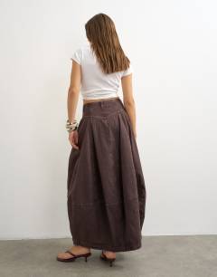 Model wearing Button front barrel maxi skirt in chocolate