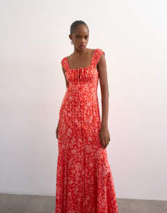 Model wearing Button front cap sleeve maxi sundress in red ditsy floral