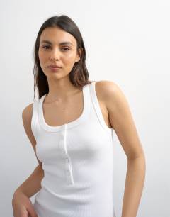Model wearing Button rib vest in white