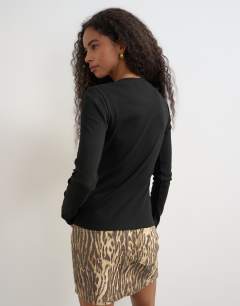 Model wearing Button through long sleeve top in black
