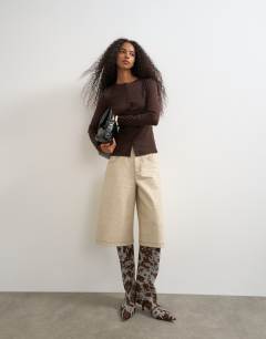 Model wearing Button through long sleeve top in chocolate