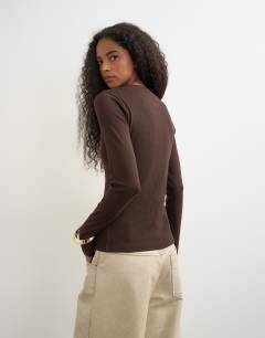 Model wearing Button through long sleeve top in chocolate