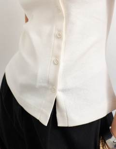 Model wearing Button through vest in ivory