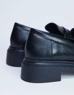 Model wearing Cade chunky sole loafer in black
