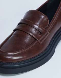 Model wearing Cade chunky sole loafer in chocolate