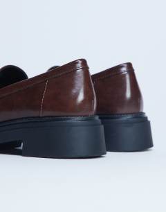 Model wearing Cade chunky sole loafer in chocolate
