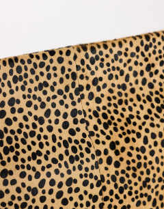 Model wearing Cam oversized hair on real leather clutch bag in leopard print