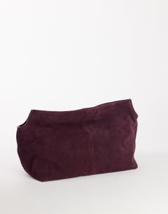 Model wearing Cam oversized real leather clutch bag in plum