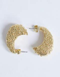 Model wearing Camille textured stud earring in gold tone