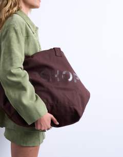 Model wearing Canvas tote bag in brown