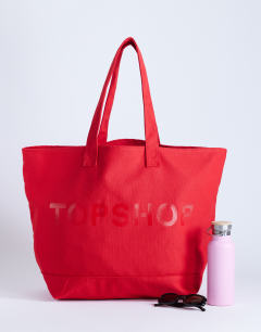 Model wearing Canvas tote bag in red