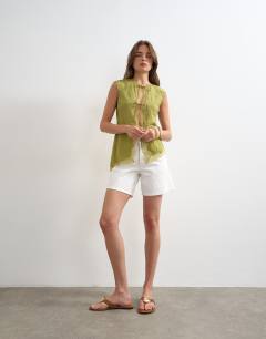 Model wearing Cap sleeve asymmetric tie front lace detail top in khaki