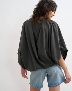 Model wearing Cape draped tee in charcoal