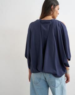 Model wearing Cape draped tee in navy