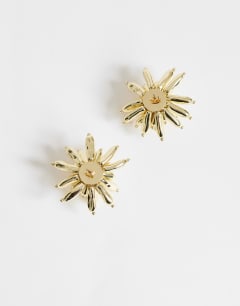 Model wearing Cara statement flower earrings in gold