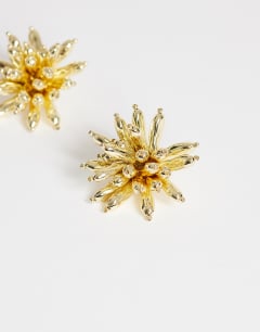 Model wearing Cara statement flower earrings in gold