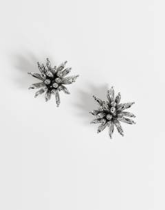 Model wearing Cara statement flower earrings in silver