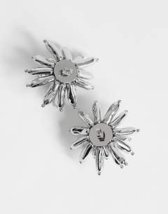 Model wearing Cara statement flower earrings in silver