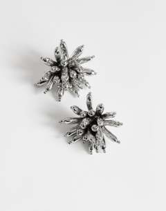 Model wearing Cara statement flower earrings in silver