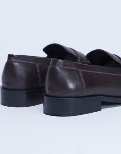 Model wearing Carey real leather loafer with ruched detail in chocolate brown