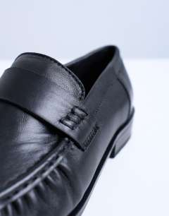 Model wearing Carey real leather loafers with ruched detail in black