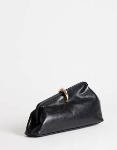 Model wearing Carlie clutch with hardware in black