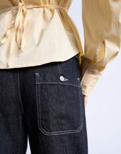 Model wearing Carpenter barrel jean in black rinse