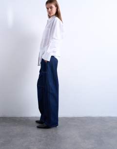 Model wearing Carpenter barrel jean in indigo rinse
