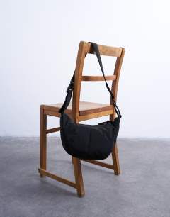 Model wearing Carrie nylon cross body bag in black