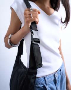 Model wearing Carrie nylon cross body bag in black
