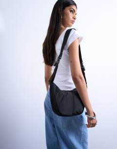 Model wearing Carrie nylon cross body bag in black