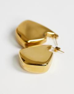 Model wearing Casey waterproof chunky hoop earrings in stainless gold