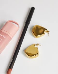 Model wearing Casey waterproof chunky hoop earrings in stainless gold