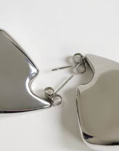 Model wearing Casey waterproof chunky hoop earrings in stainless silver