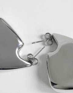 Model wearing Casey waterproof chunky hoop earrings in stainless silver