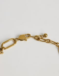 Model wearing Casidy waterproof stainless steel chain bracelet with charms in gold