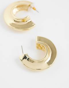 Model wearing Cassie chunky hoop earrings in gold tone