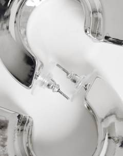 Model wearing Cassie chunky hoop earrings in silver tone